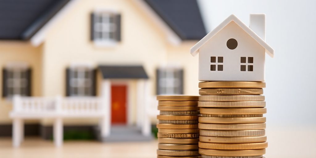 House with coins representing home insurance and investment.