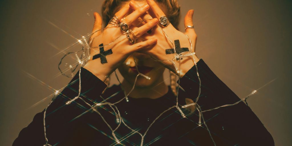 a woman covering her face with her hands