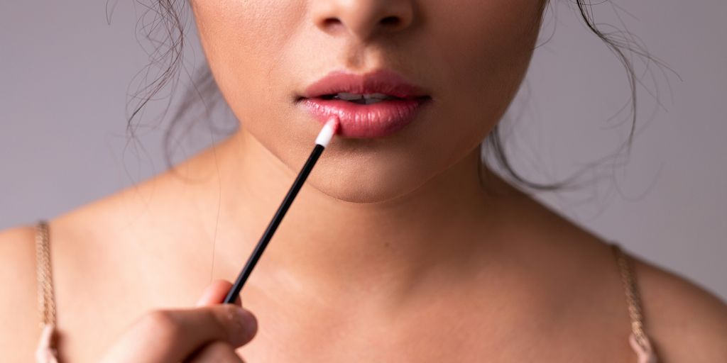 woman with red lipstick and black mascara