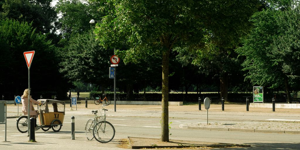 a person riding a bike on a city street