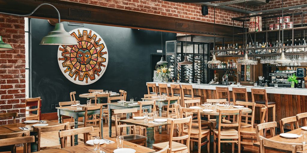 a restaurant with wooden tables and chairs