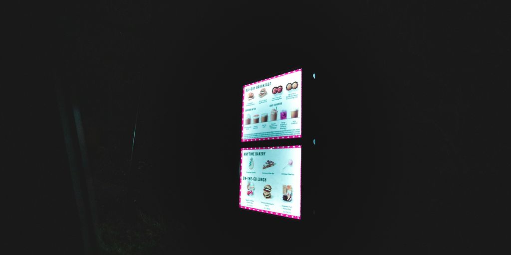 a dark room with two screens on the wall