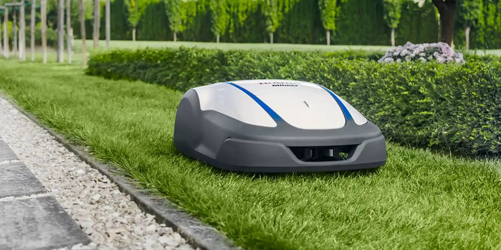 Robotic lawn mower on a neatly trimmed grassy area.