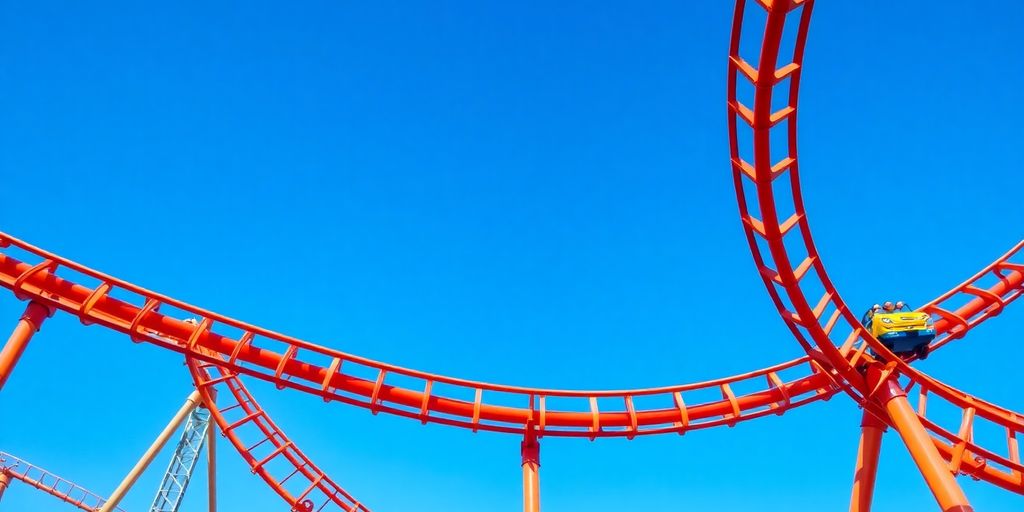 Rollercoaster track curving against a bright blue sky.