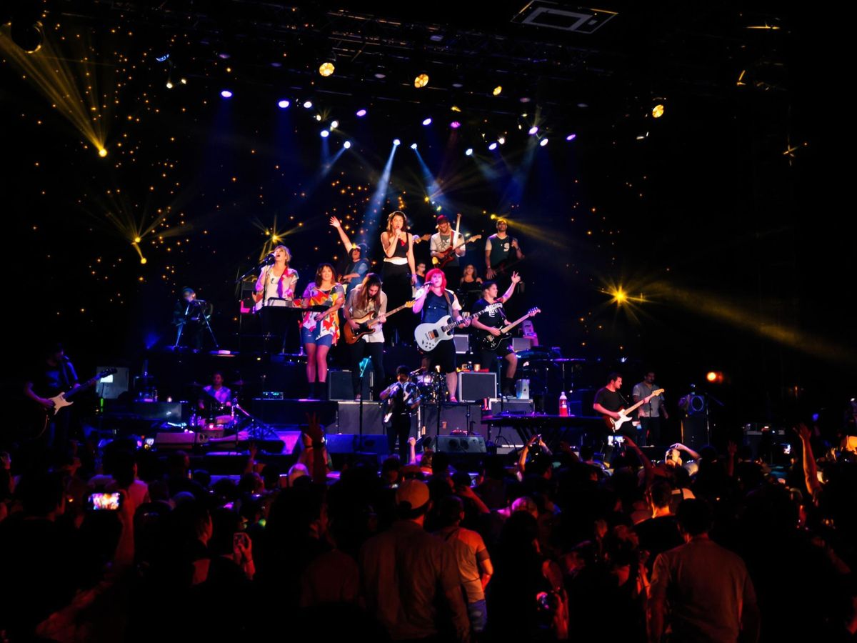 Indie musicians perform energetically in a lively setting.