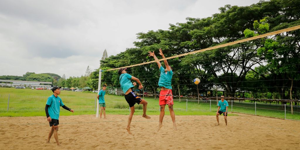 a group of young men playing a game of volleyball