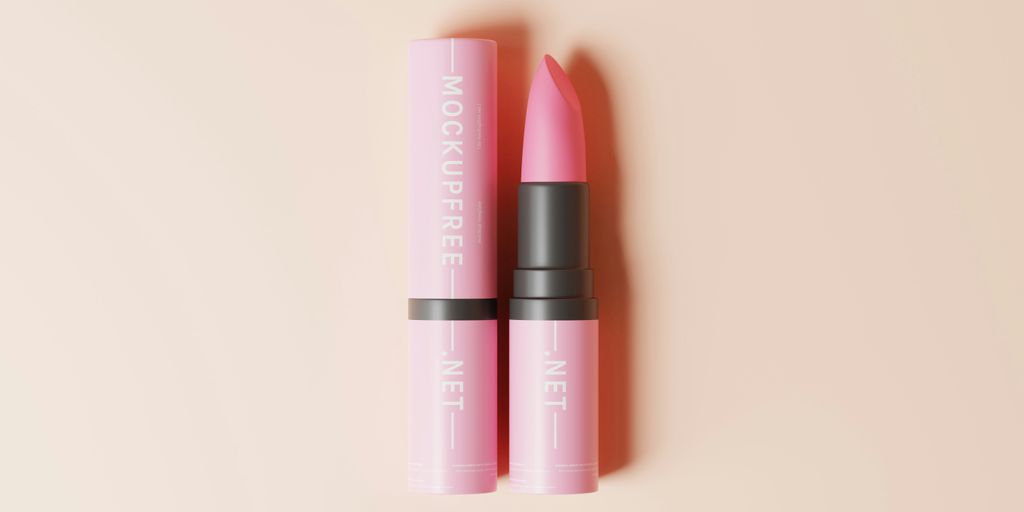two pink lipsticks sitting next to each other