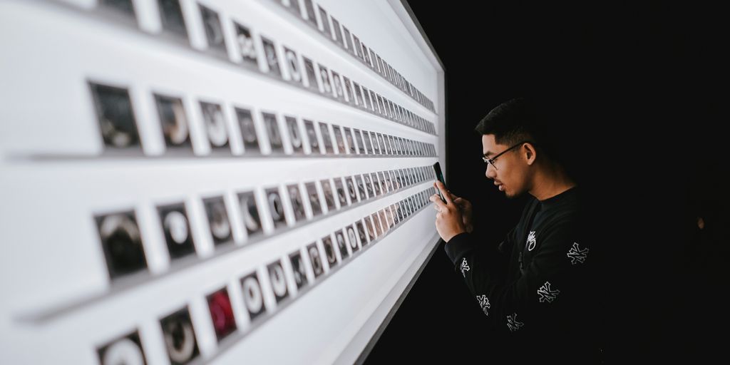 standing man while using smartphone