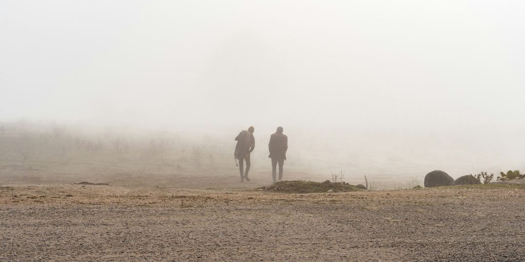 a couple of people that are standing in the dirt