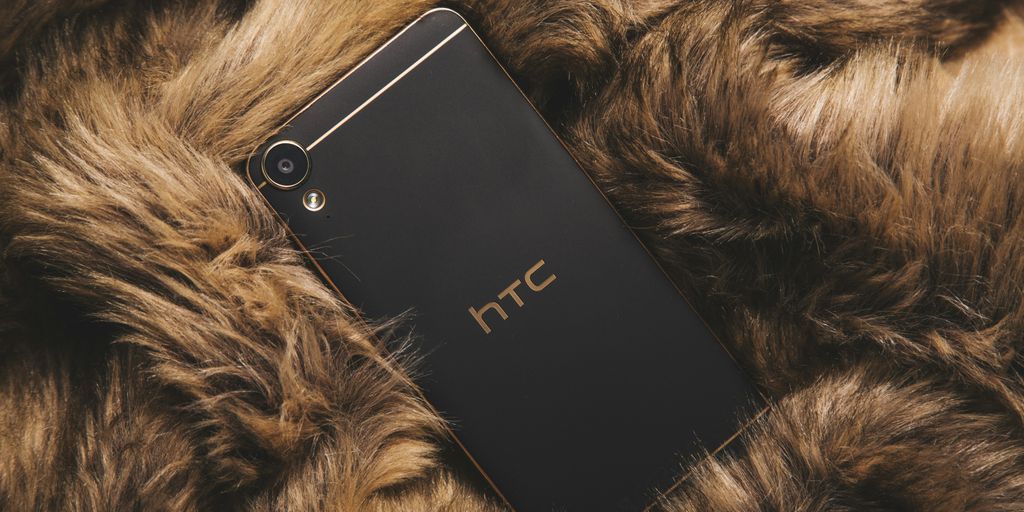 black HTC smartphone on fur textile