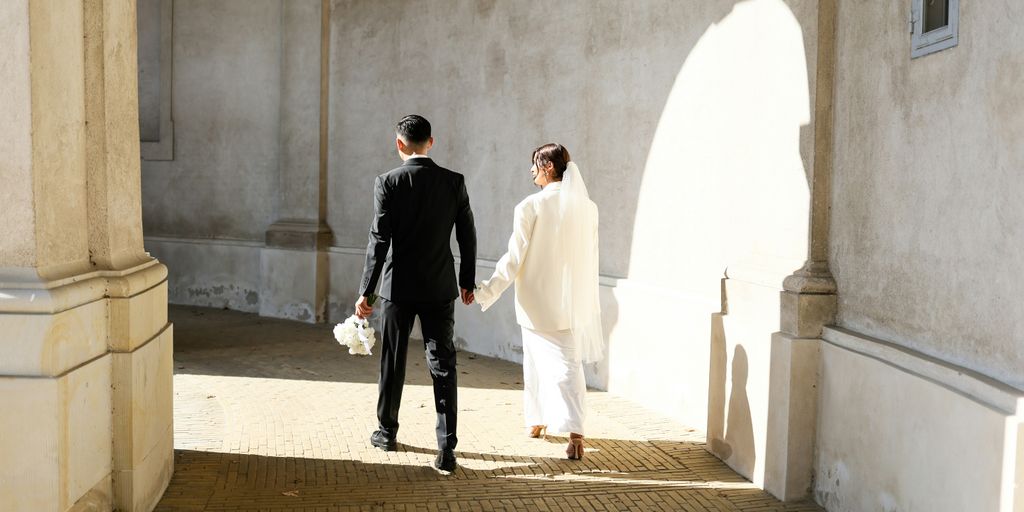A couple of people that are walking down a street