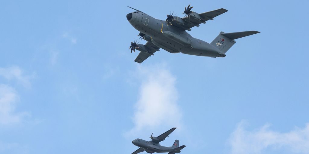 A group of planes flying in formation in the sky