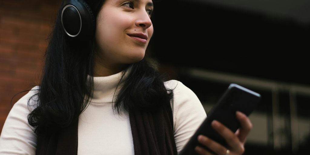 woman holding a smartphone and smiling