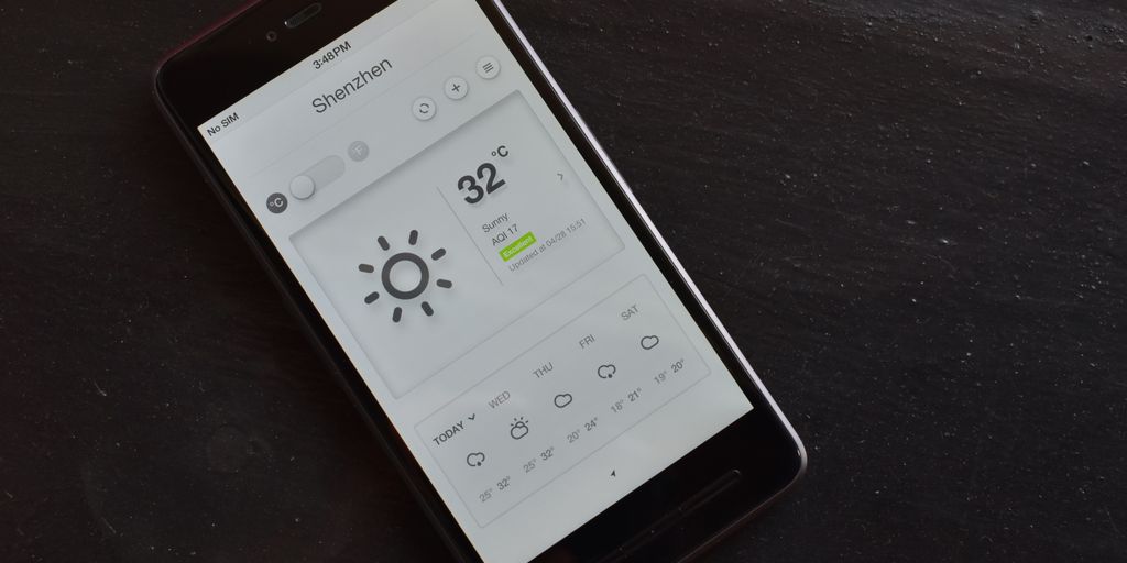 a cell phone with a weather station on the screen