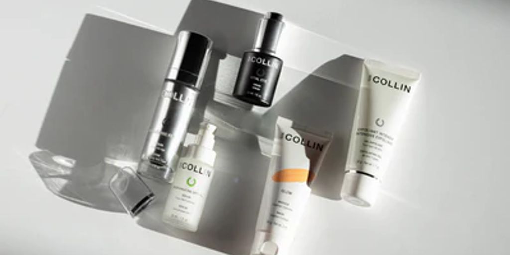Various skincare products arranged neatly on a reflective surface.