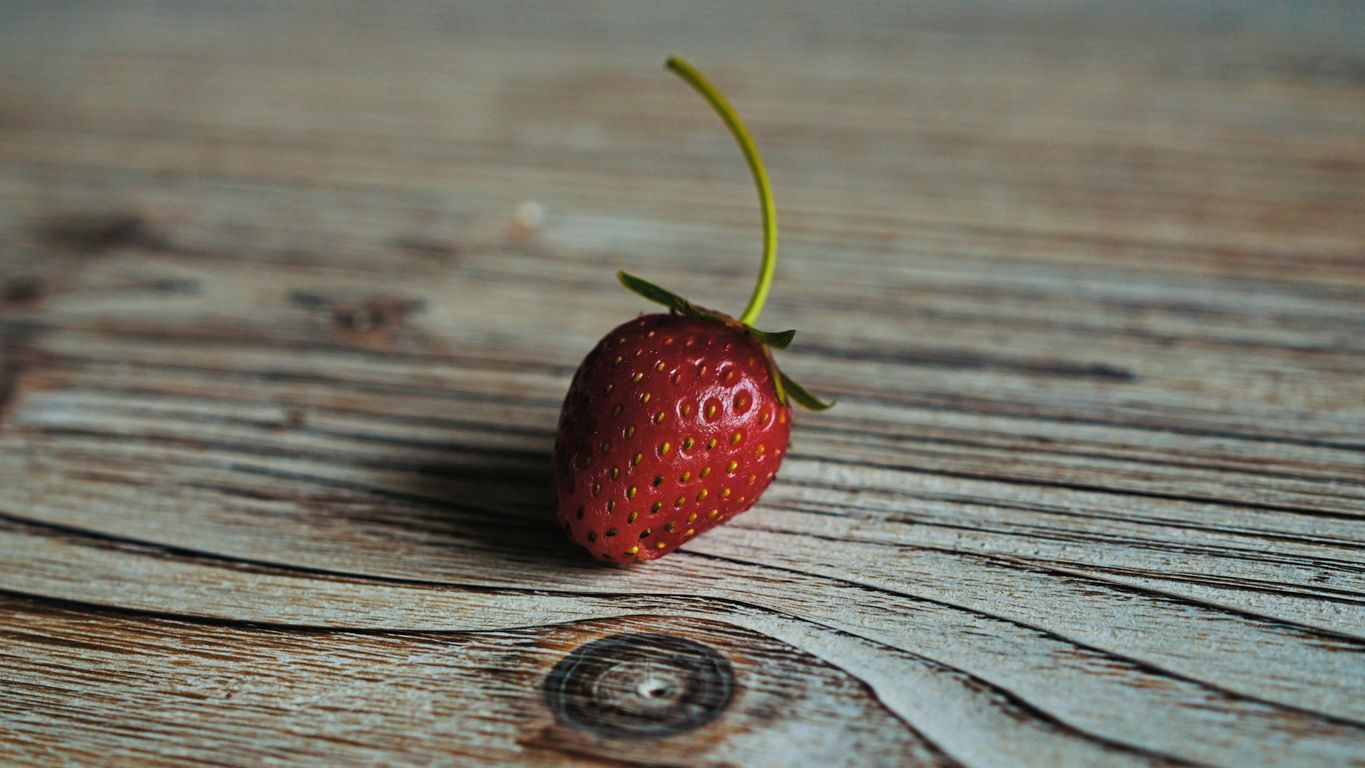 strawberry on wooden surface