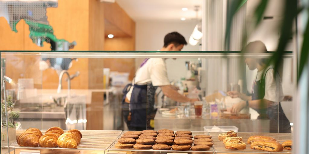 Fresh pastries are displayed in a cafe's showcase.
