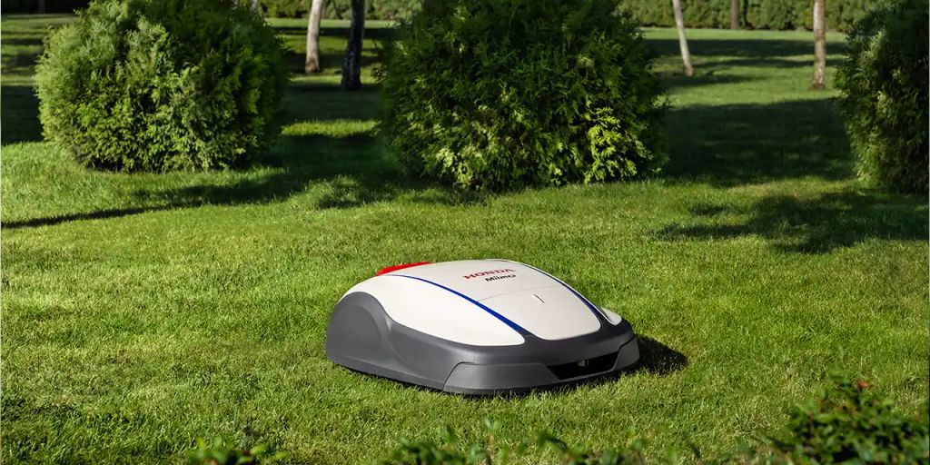 A robotic lawn mower cutting grass in a garden.