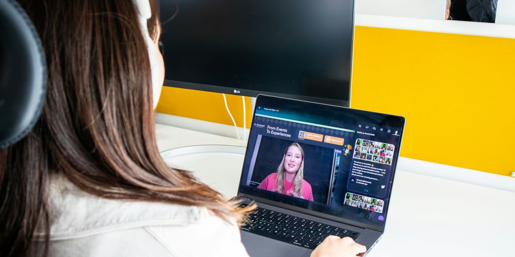 a woman sitting in front of a laptop computer
