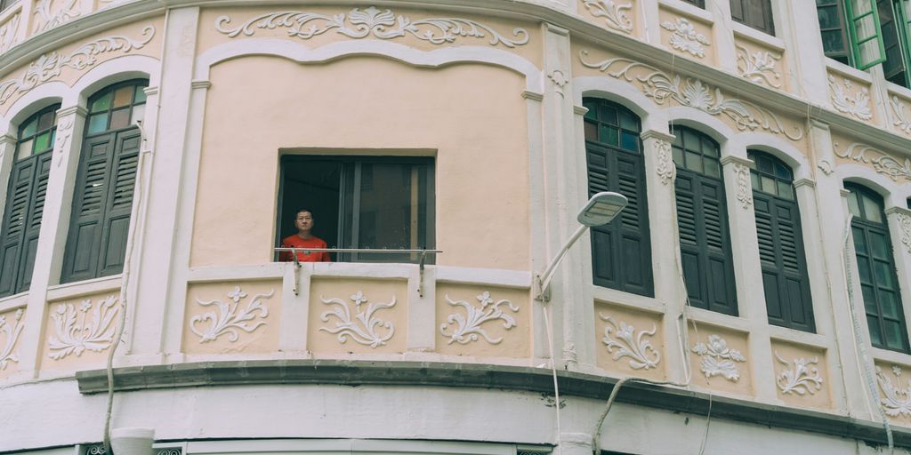 a person standing in a window of a building