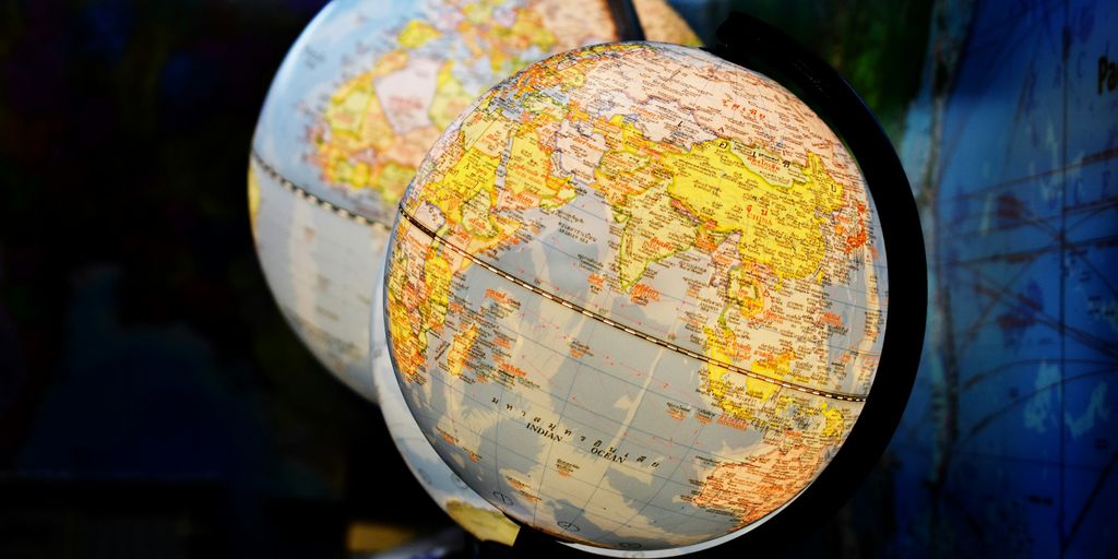 shallow focus photography of two desk globe