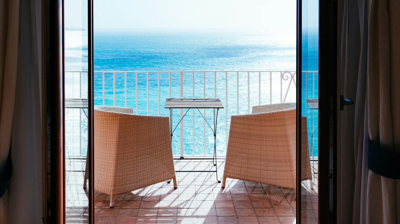 two wicker chair near fence