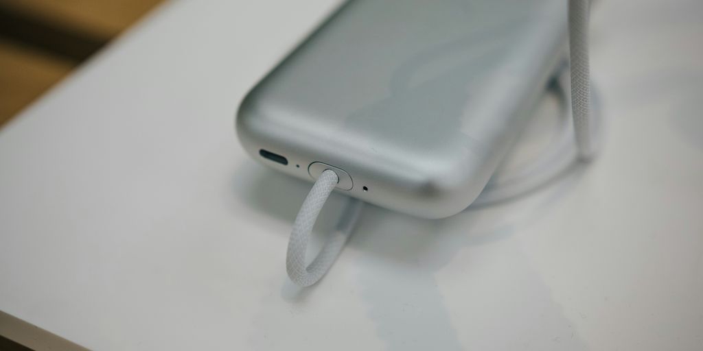 a cell phone plugged into a charger on a table