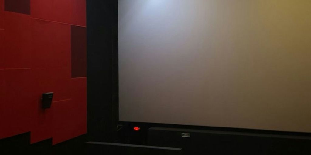 Empty movie theater screen awaiting a film.