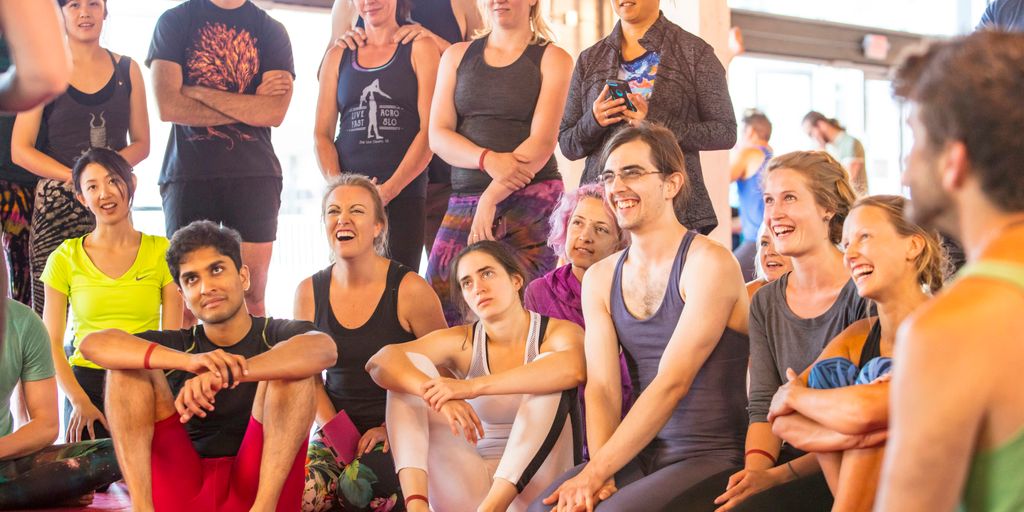 a group of people sitting and standing around each other