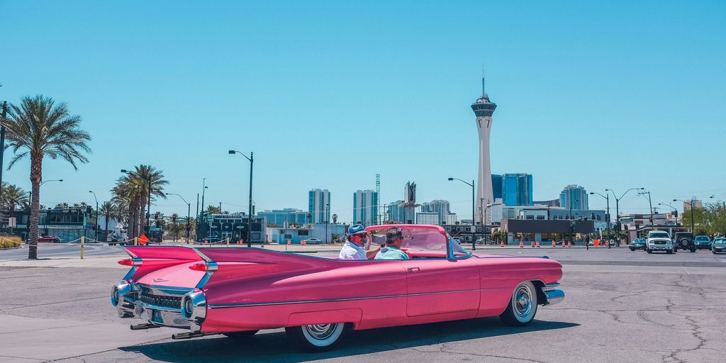 people riding pink car