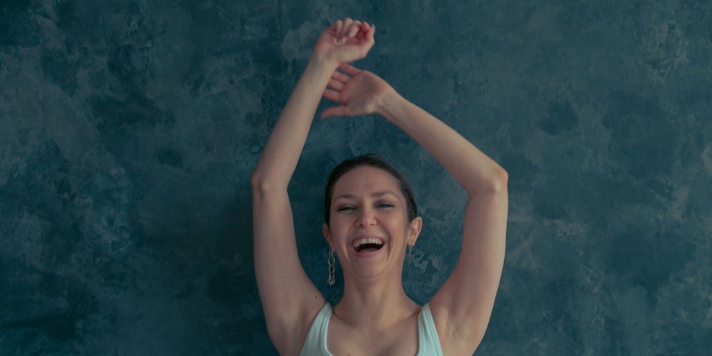 a woman with her arms up in the air