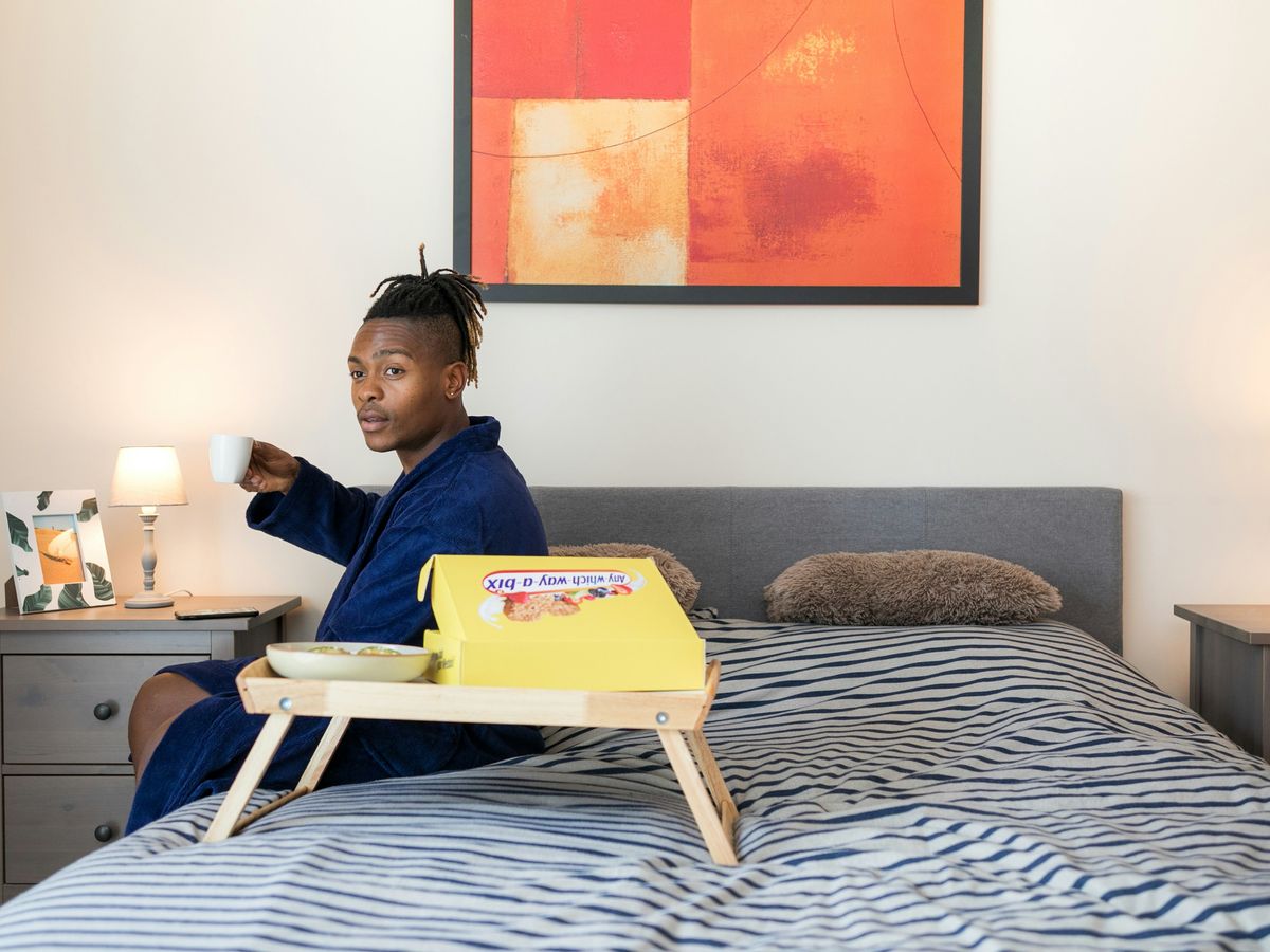 man sits on bed