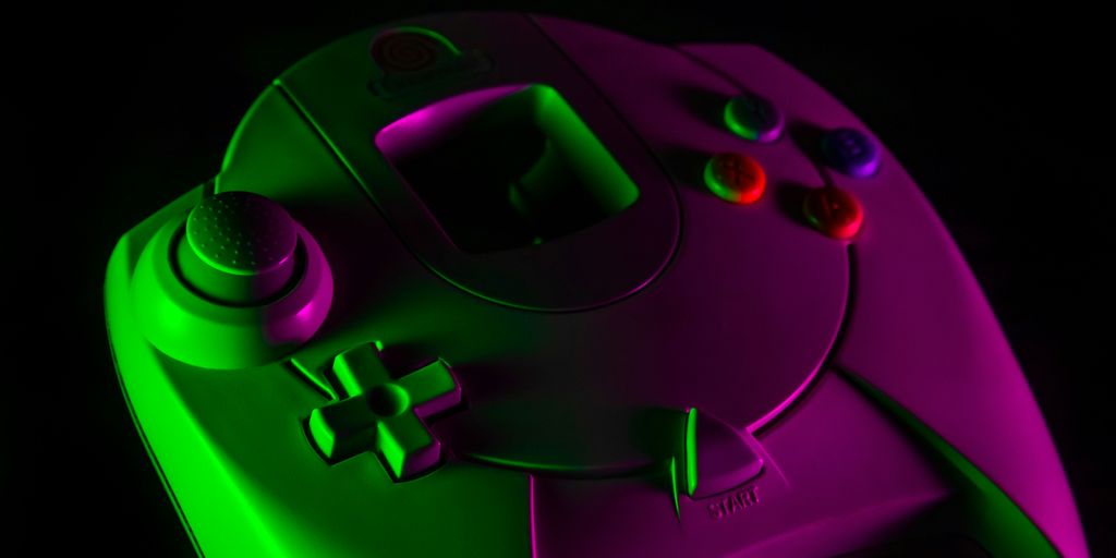 purple game controller on black surface
