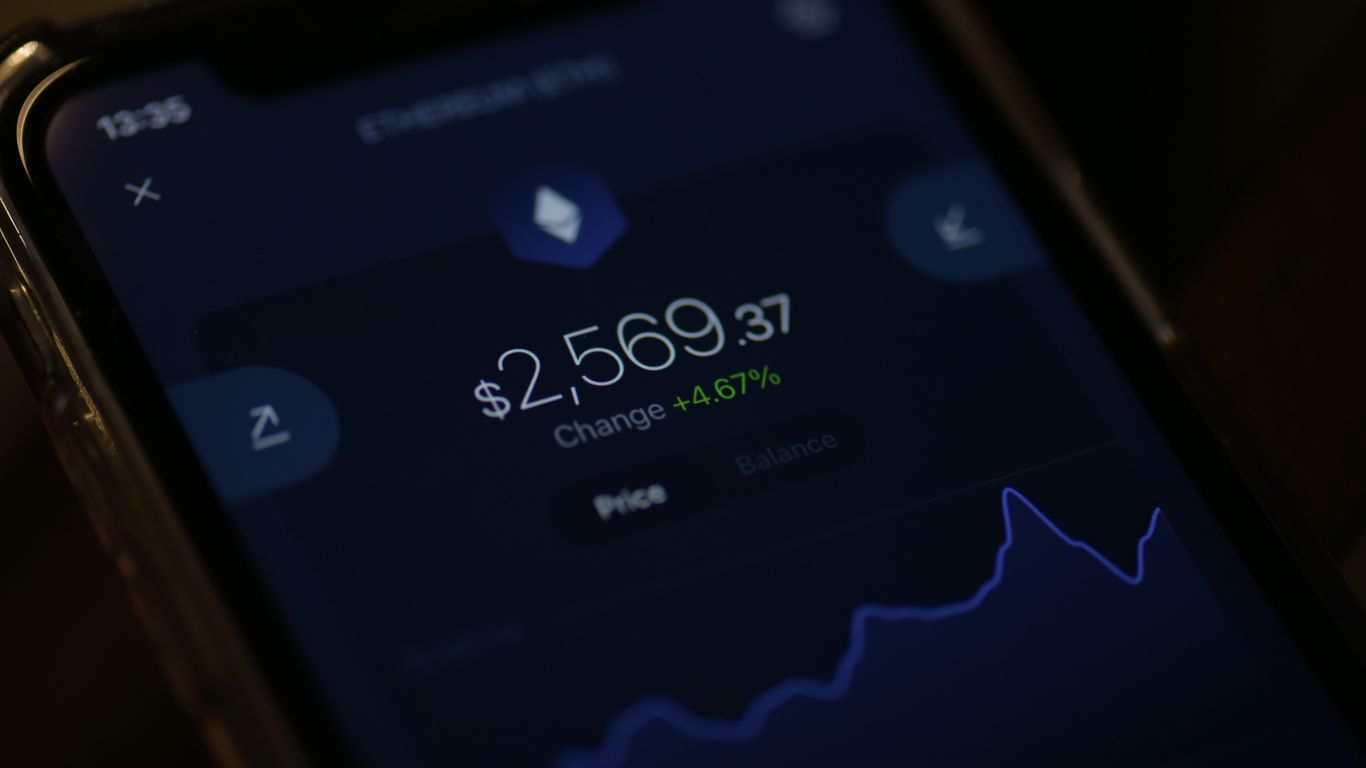 A smartphone displaying Ethereum price and change percentage.