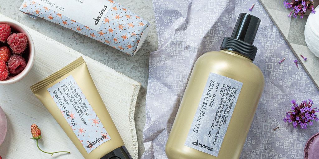 Cosmetic products, packaging, natural ingredients, lavender, light stone background.