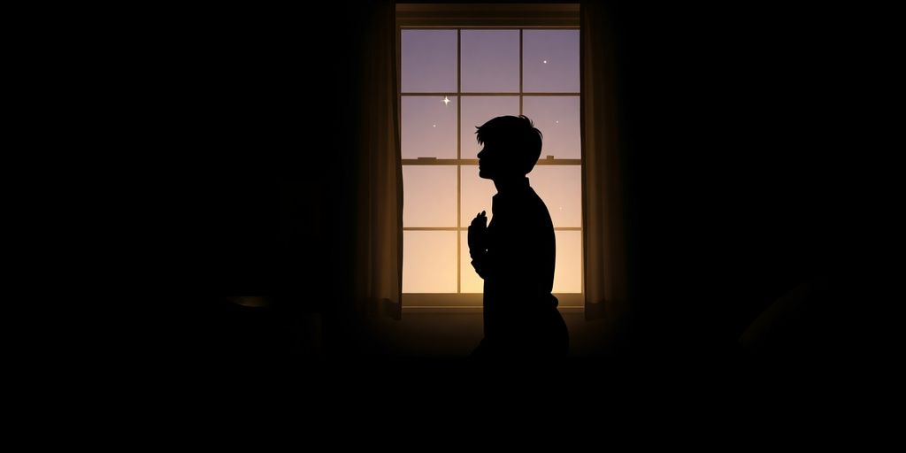 Silhouette of a person praying by a bedside at night.