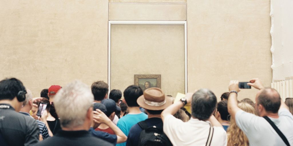 people taking photo of Mona Lisa painting