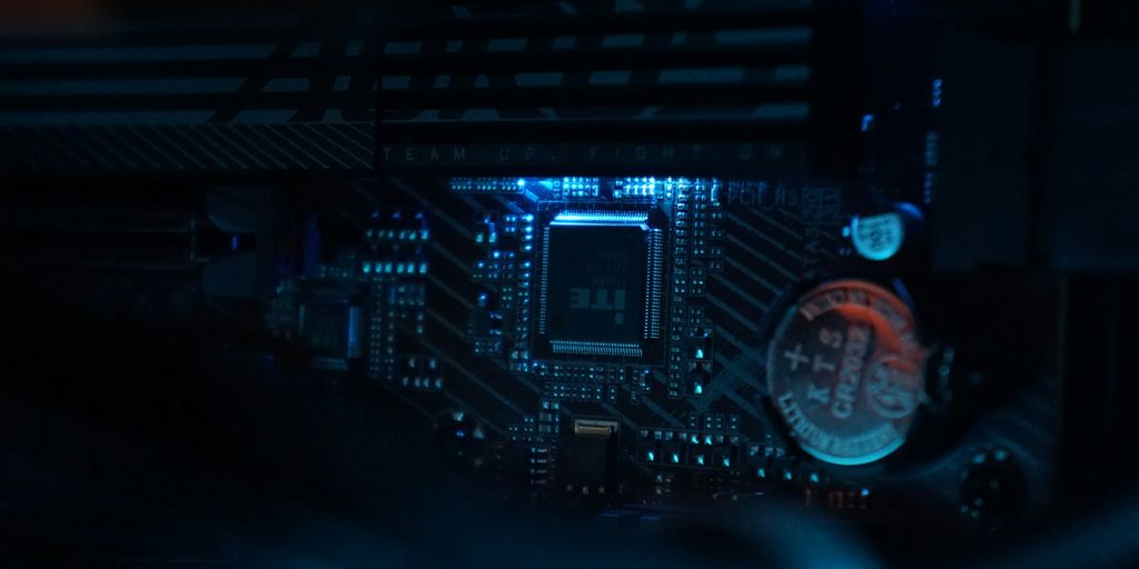 A close up of a computer motherboard in a dark room