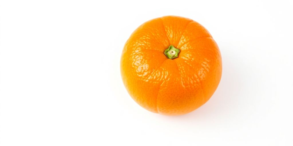 A bright orange sitting alone on a clean, white surface.