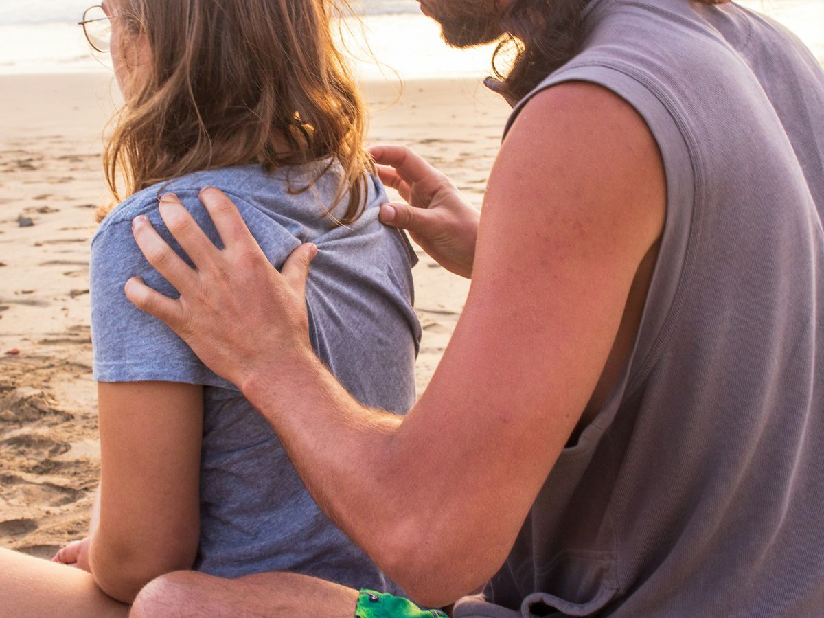 man massaging woman at the back