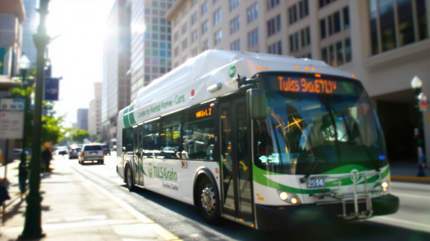 Tulsa transit bus in motion on a sunny day.
