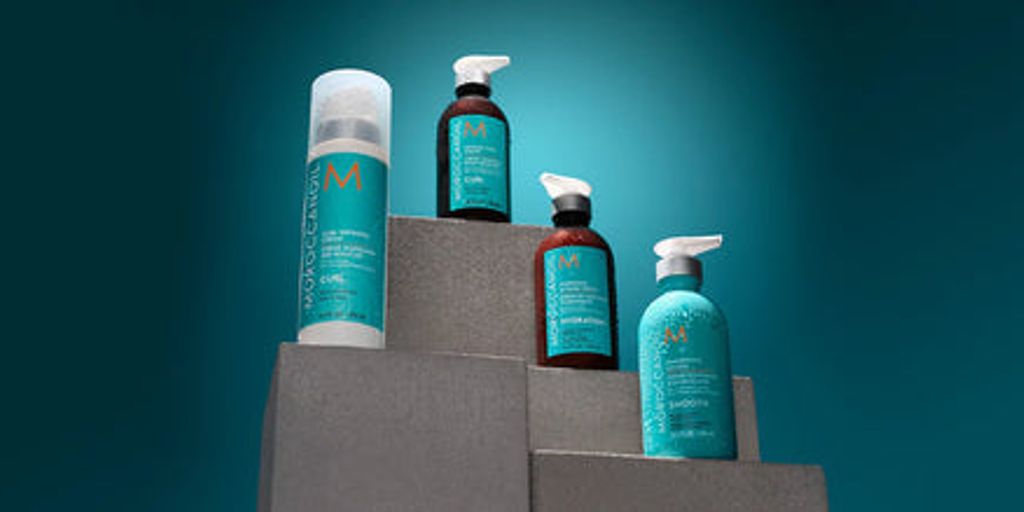 Haircare products displayed on ascending gray blocks, teal backdrop.