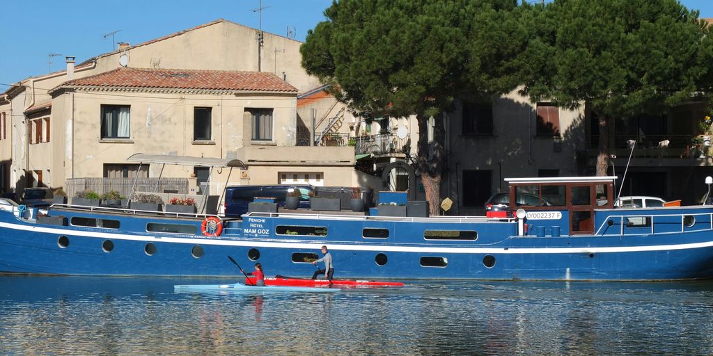 a blue boat floating on top of a body of water