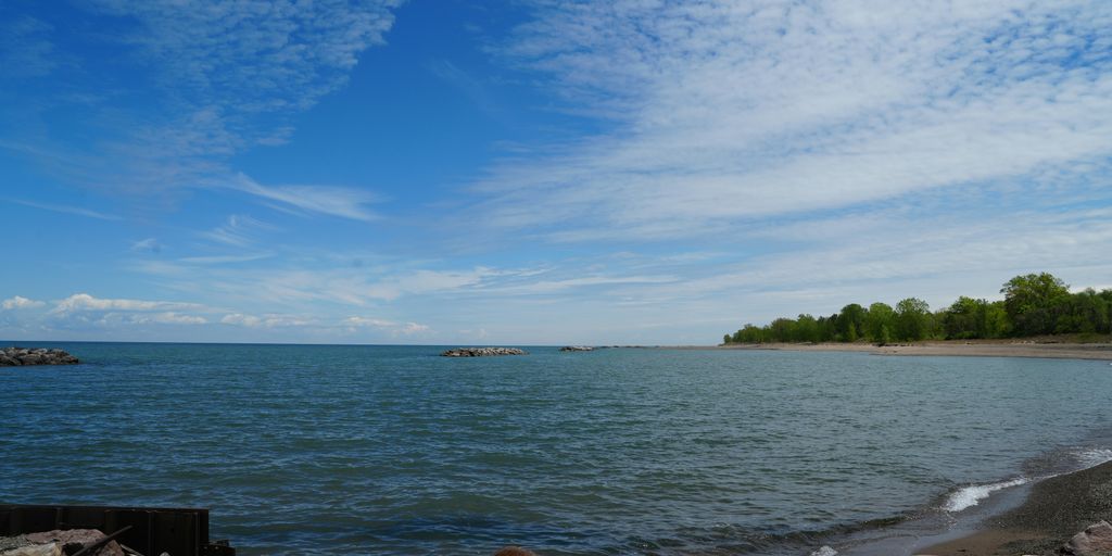 A view of a body of water from a rocky shore