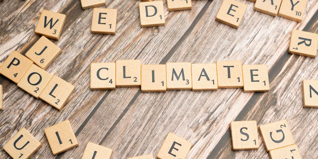 scrabble tiles spelling climate on a wooden surface