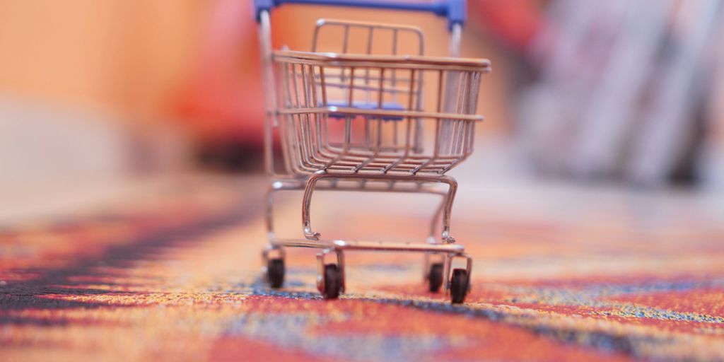 a miniature shopping cart sitting on top of a rug