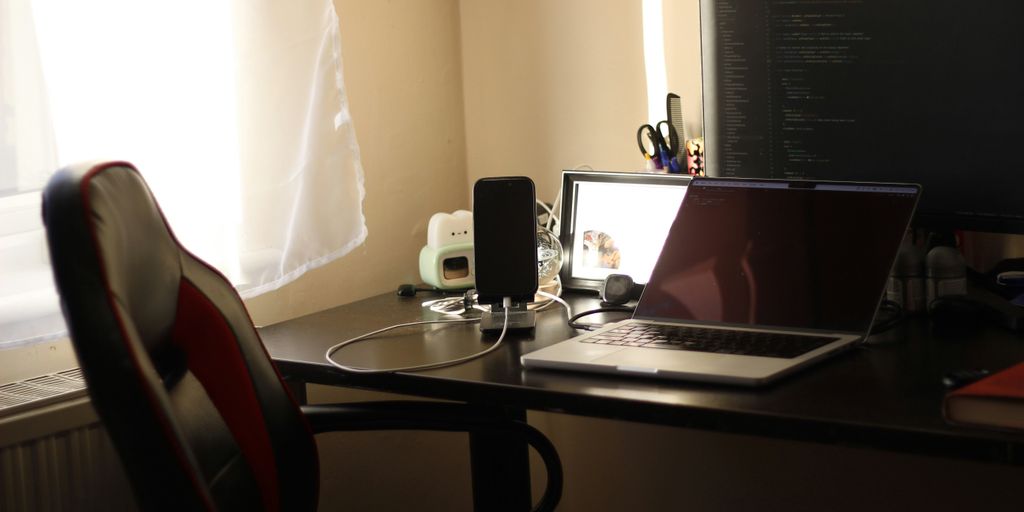 A desk with a laptop and a monitor on it