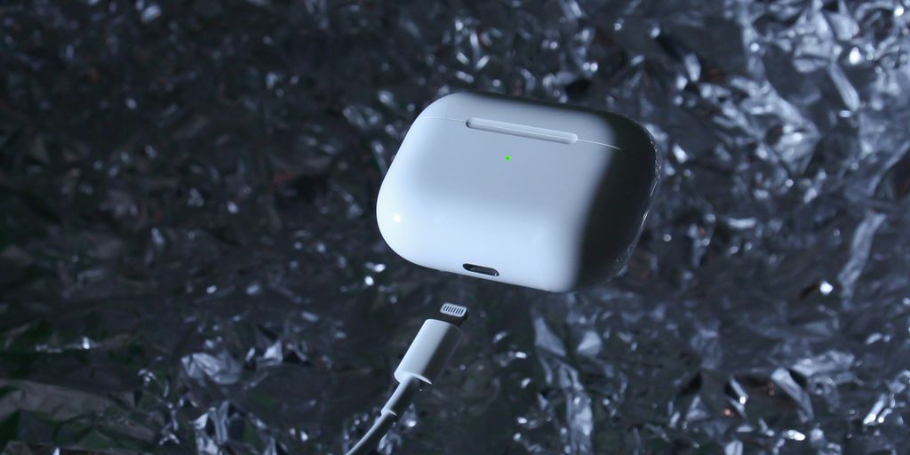 white charging adapter on black and gray surface