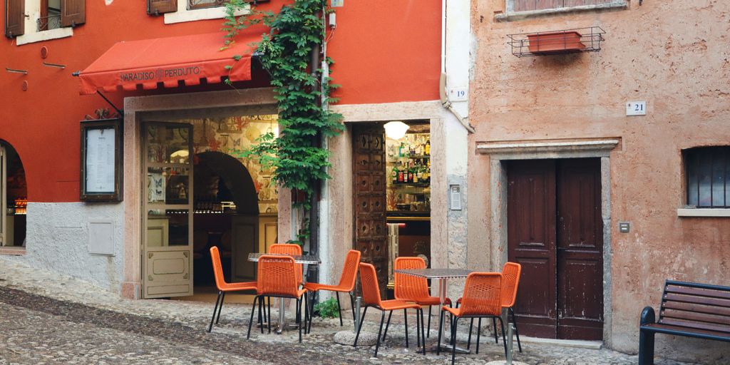 a row of orange chairs sitting in front of a building