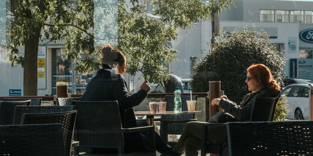 man in black suit jacket sitting on black chair
